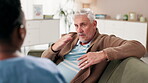 Senior, man and sofa for conversation with caregiver for consultation, daily activities and information on homecare wellbeing. Female nurse, elderly person and discussion on couch for health concern.