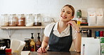 Portrait, woman and chef with apron, kitchen and proud of culinary skills, confident and ready for cooking. Hotel, cook and employee in hospitality, happy and professional with smile for catering