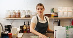 Cleaning, woman and chef with wipe, kitchen and proud of culinary skills, confident and done with cooking. Hotel, cook and employee in hospitality, serious and professional with apron for catering