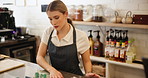 Cleaning, woman and chef with cloth, kitchen and proud of culinary skills, confident and done with cooking. Hotel, table and employee in hospitality, serious and professional with apron for catering