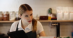 Woman, tablet and waitress for stock management, small business and employee in cafe. Female person, barista and technology for check, industry and hospitality with quality control, serious and work