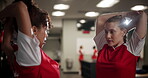 Conversation, soccer player women and stretching in locker room of venue for game, match or sports. Exercise, fitness and arm up with football friends speaking for competition, tactics or teamwork