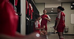 Soccer, team and women talking to coach for advice, stretching and warm up for game in locker room. Happy girls, football and friends with training instructor getting ready for sport with checklist