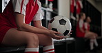 Girl, hands and soccer with ball in locker room for preparation or getting ready with team for game. Closeup of female person or sports player waiting with football for half time, next match or play