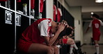 Locker room, stress and woman soccer player with failure at game, training or tournament in Paris. Upset, sports and female football athlete in cloakroom thinking of mistake in match or practice.