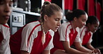 Group, athlete and thinking of soccer, sports and teammates with anxiety for match in locker room. Football player, women and nervous of competition, contemplating and scared of results of game