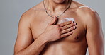 Skincare, hand of man or cream on body in studio for routine, healthy skin or moisturizing. Person, chest or topless on gray background with lotion, sun protection and dermatology product application