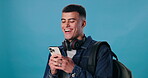 Student, phone and laugh with funny joke, comic or meme on blue background with mockup for social media. Smile, happy and young gen z man reading from app on smartphone with website for communication