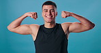 Face, flexing arms and man with wellness, fitness and happiness on blue studio background. Portrait, bodybuilder and model with bicep, strength or power with energy, proud or workout with results