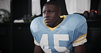 Black man, thinking and game plan with football in locker room for match, break or half time. Young African, athlete or male person getting ready in wonder for ideas, sports tournament or competition