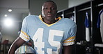 Black man, American football and helmet in locker room for sport, face and ready for game in competition. Serious person, athlete and player in portrait for contest, club and franchise in Florida