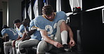 Team, locker room and football athlete preparing for game or practice at stadium field. Fitness, uniform and man tie laces in cloakroom getting ready for training or match of American contact sport.