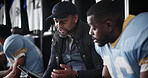 Black man, coach and football with tablet in locker room for game plan, strategy or layout to team captain. African mentor, athlete or sports trainer with technology for brainstorming match or play