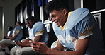 Football, smile and man with smartphone, typing and social media in locker room, texting and app. Person, sports team or player with cellphone, mobile user and internet with connection or online joke