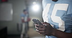 Football, hands and man with smartphone, typing and social media in locker room, texting and app. Closeup, sports and guy with cellphone, mobile user and internet with connection, contact or chatting