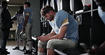 Football, player and man with cellphone in locker room and social media with message, texting and app. Wellness, sports and person with smartphone, mobile user or internet with connection or chatting