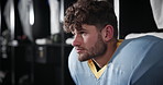 Football, thinking and man in locker room with stress for loss in match, game and competition. Sports, athlete and person with worry, frustrated and upset for defeat, losing and disappointed