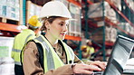 Woman, laptop and typing in logistics warehouse for inventory management, tracking and reporting shipment status. Female employee, factory and online for supplier communication and order processing.