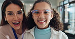 Helping, woman and glasses for child, store and vision for girl, high five and happy with choice of healthcare. Shopping, customer and portrait of eyewear, optician and employee with smile for kid