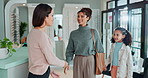 Woman, optometry and child for eye care, medical professional and optometrist for consultation. Female people, handshake and specialist in greeting at ophthalmology center for glasses, health or help