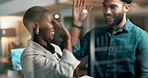 Woman, man and high five for celebration at office in night with tablet for support, success or goals. People, diversity and partner for cheers, synergy and connection for teamwork at creative agency