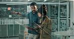 Business people, planning and discussion with tablet on glass board for company growth, finance or profit at office. Young businessman and woman discussing corporate graph with technology for revenue