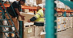 Packaging, men and boxes with teamwork in warehouse for supply chain, cargo product stock and shipping. Distribution industry, people and collaboration with packing, loading and logistics in trolley