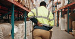 Logistics, boxes and man in warehouse with back pain, injury or accident on site for cargo inventory. Pallet truck, stock and freight operator with spinal osteoarthritis or muscle sprain in factory.