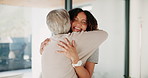 Hug, happy and senior mother with woman in house for connection, care and bonding together. Smile, family and elderly mom embracing daughter for greeting at visit for sweet moment in retirement home.