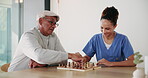 Chess, senior man and nurse playing at table for moving, strategy or board game challenge. Solution, decision and elderly person with woman caregiver for cognitive skills, tactics or retirement home