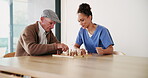 Chess, elderly man and nurse playing at table for moving, strategy or board game challenge. Solution, decision and senior person with woman caregiver for cognitive skills, tactics or retirement home