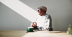 Relax, thinking and elderly man in cafe with drink, cappuccino or calm morning break on retirement holiday. Remember, memory and old person at table in coffee shop with peace, nostalgia and wellness