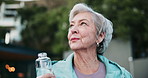 Thinking, fitness and senior woman outdoor with location for walking exercise with water for hydration. Health, wellness and elderly female person with h2o beverage for cardio workout in nature.