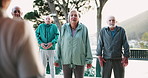 Fitness, mobility and personal trainer with senior yoga class outdoor in city for exercise or wellness. Assisted living, pilates or rehabilitation and elderly group with coach for shoulder stretching