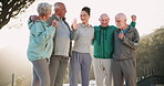 Hug, outdoor and senior people with fitness, trainer and sunshine with nature, smile and exercise. Friends, coach and group in park, support and trust with workout, wellness and healthy with training