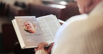 Closeup, bible and person in church, pamphlet and belief with faith, spiritual and grief with loss. Memory, scripture and Christian with holy text, guidance and religion with nostalgia and remember