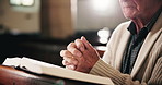 Bible, prayer and hands of old man in church with faith, gratitude or spiritual respect in meditation. Praise, religion and elderly person in chapel with book for morning service, worship and peace