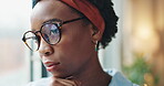 Business, black woman and thinking by window in office with contemplating or pondering on ideas with glasses. Professional, serious employee and thoughtful at workplace with daydreaming for solution 