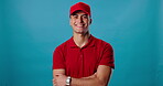 Delivery man, face or arms crossed for business, distribution service or supplier on blue background. Confident, supply chain and portrait of happy courier worker for shipping and trust in studio