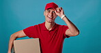 Delivery man, face or greeting in studio for box distribution, trust and supplier on blue background. Friendly, supply chain stock and portrait of happy courier worker with shipping package or goods