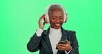 Black woman, headphones and smartphone for dancing on green screen, employee break and studio. Female person, hearing audio and professional for work motivation, streaming radio and online for sound