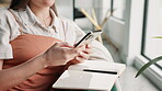 Woman, phone and research with journal in home living room for planning schedule or checklist. Book, creative and digital notes of freelancer for remote work, copywriting or ideas for article editor