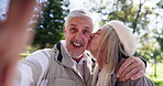 Senior, couple and kiss in park for selfie with love connection, affection and embrace for personal vlog. Elderly people, face and streaming in garden for social media post, memory and relationship.