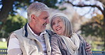 Elderly, couple and happy on park bench with love connection, affection and embrace for commitment. Senior people, relax and laughing in garden for relationship bonding, support and outdoor with joy.