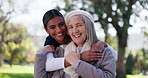 Senior woman, nurse and caregiver with hug in nature for love, support or care at outdoor park. Portrait of elderly patient or physiotherapist with smile for embrace, commitment or trust together