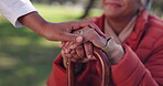 Nature, hands and person with disability for senior care, support and comfort in park. Elderly woman, cane and caregiver in garden for empathy, trust and rehabilitation in retirement or nursing home