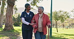 Old woman, nurse help and cane for walking assistance in outdoor, talk and arthritis rehabilitation. Person with disability, caregiver and garden for balance, support and speak in park for recovery