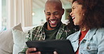 Happy, african couple and relax with tablet on sofa for funny video, comedy movie and laughing for social media meme. Man, woman and together in home with internet for entertainment and streaming.