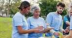 Clipboard, nature and group of volunteers with donations for community work at event at outdoor park. Charity, people and ngo team with food boxes or package for distribution in field with checklist.