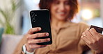 Happy woman, hands and online shopping with credit card or phone on sofa for payment, banking or fintech at home. Closeup of female person or shopper with debit on mobile smartphone for ecommerce